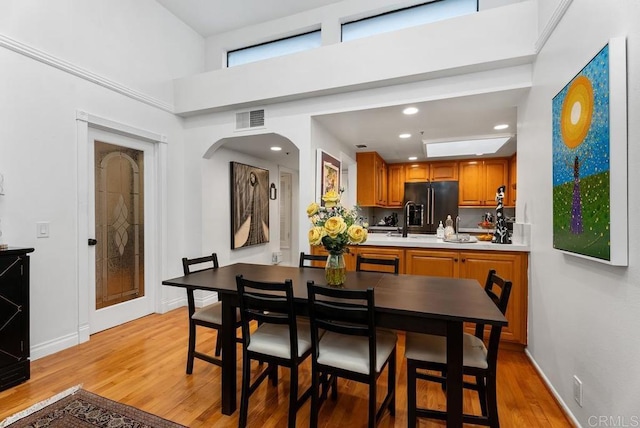 270 Cagney Ln Unit 315, Newport Beach, CA 92663 - dining space featuring light wood-type flooring, baseboards, recessed lighting, and a high ceiling