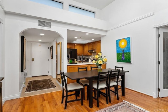 270 Cagney Ln Unit 315, Newport Beach, CA 92663 - dining space with arched walkways, light wood-style flooring, baseboards, and recessed lighting