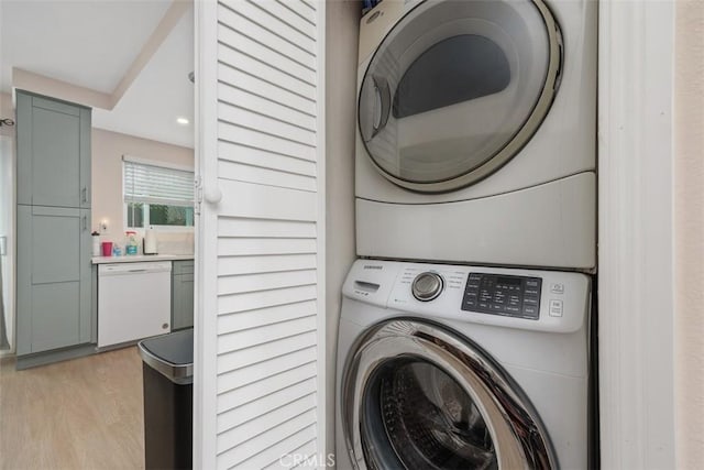 3404 Los Mochis Way, Oceanside, CA 92056 - laundry room with stacked washer / drying machine and light wood finished floors