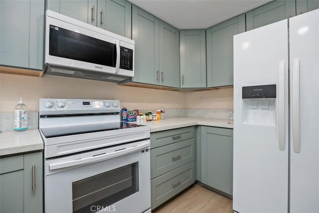 3404 Los Mochis Way, Oceanside, CA 92056 - kitchen featuring white appliances, light wood-type flooring, and green cabinetry