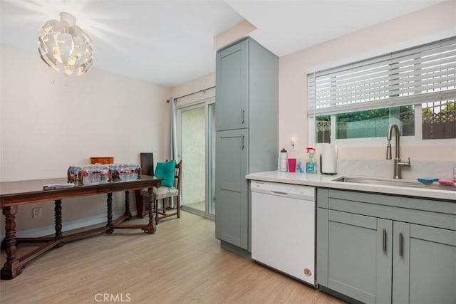 3404 Los Mochis Way, Oceanside, CA 92056 - kitchen featuring white dishwasher, a sink, light wood-style floors, light countertops, and gray cabinets
