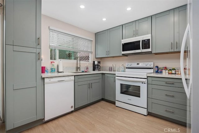 3404 Los Mochis Way, Oceanside, CA 92056 - kitchen with white appliances, a sink, light wood-style flooring, gray cabinets, and recessed lighting