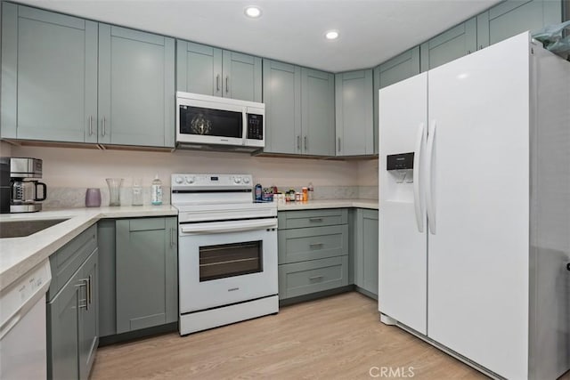 3404 Los Mochis Way, Oceanside, CA 92056 - kitchen with white appliances, light wood finished floors, light countertops, and recessed lighting