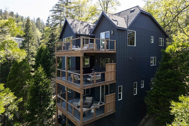 357 Mittry Ln, Lake Arrowhead, CA 92352 - rear view of property featuring a shingled roof, a wooden deck, and a balcony