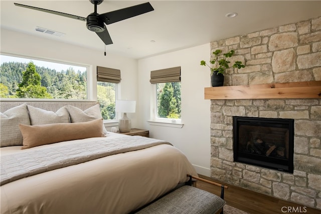 357 Mittry Ln, Lake Arrowhead, CA 92352 - bedroom featuring wood finished floors, baseboards, a ceiling fan, and a stone fireplace