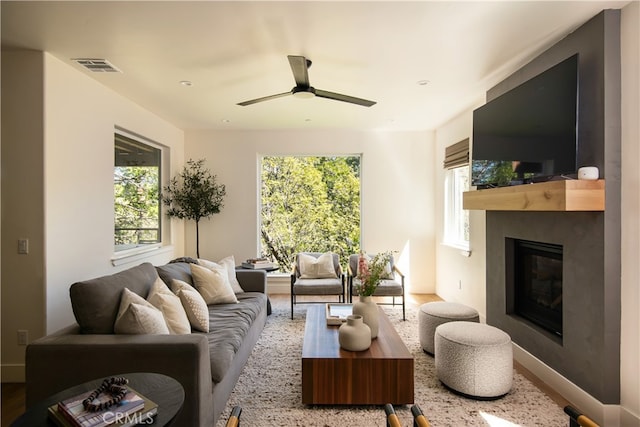 357 Mittry Ln, Lake Arrowhead, CA 92352 - living area with a large fireplace, ceiling fan, wood finished floors, and baseboards