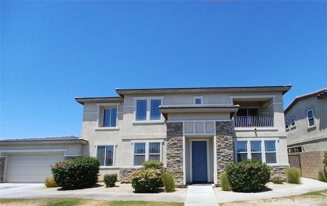 83448 Stagecoach Rd, Indio, CA 92203 - prairie-style home featuring stone siding, stucco siding, a garage, and a balcony