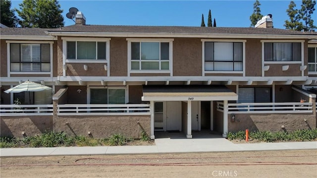 949 W Imperial Blvd Unit 14C, La Habra, CA 90631 - townhome / multi-family property with stucco siding and a chimney
