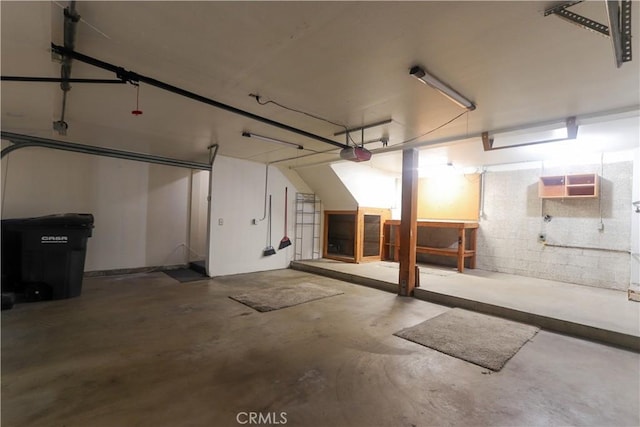 949 W Imperial Blvd Unit 14C, La Habra, CA 90631 - garage featuring a garage door opener and concrete block wall