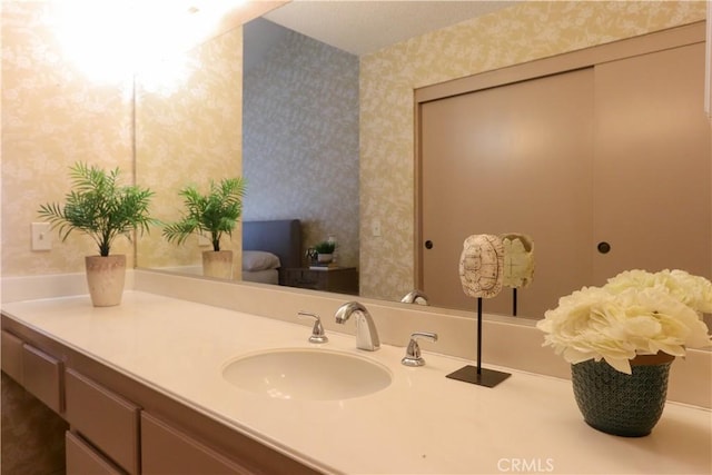 949 W Imperial Blvd Unit 14C, La Habra, CA 90631 - bathroom featuring wallpapered walls and vanity
