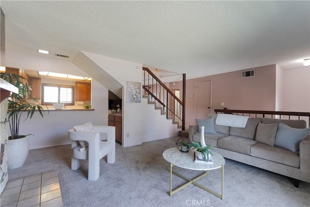 949 W Imperial Blvd Unit 14C, La Habra, CA 90631 - living area featuring light carpet, stairs, and a textured ceiling