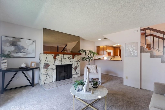 949 W Imperial Blvd Unit 14C, La Habra, CA 90631 - living area featuring light colored carpet, stairs, a textured ceiling, and a stone fireplace
