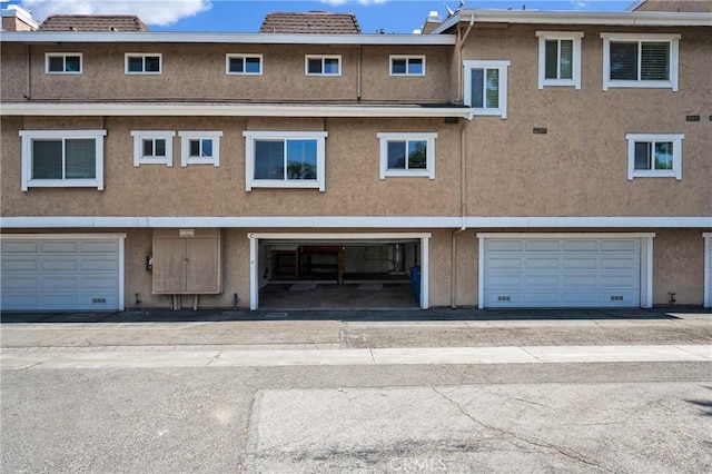 949 W Imperial Blvd Unit 14C, La Habra, CA 90631 - rear view of property featuring stucco siding and an attached garage