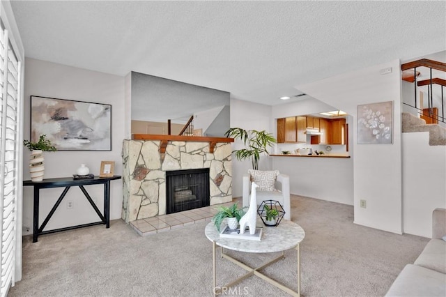 949 W Imperial Blvd Unit 14C, La Habra, CA 90631 - living room featuring carpet, stairway, a stone fireplace, and a textured ceiling