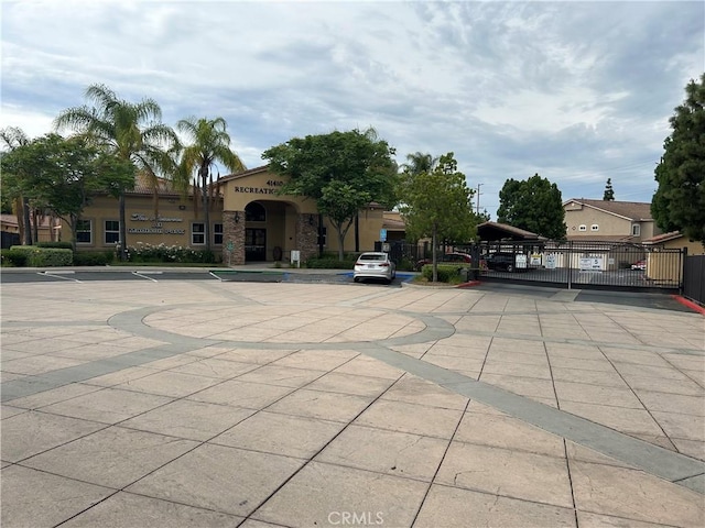 41410 Juniper St Unit 2012, Murrieta, CA 92562 - view of front of house with a gate and stucco siding