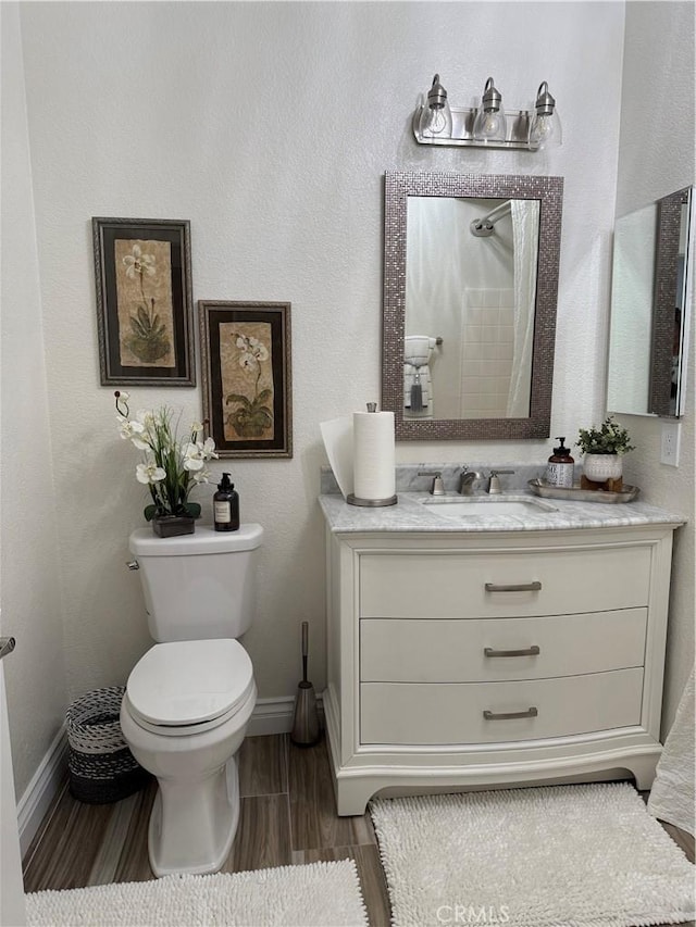 41410 Juniper St Unit 2012, Murrieta, CA 92562 - bathroom with vanity, toilet, wood finish floors, and baseboards