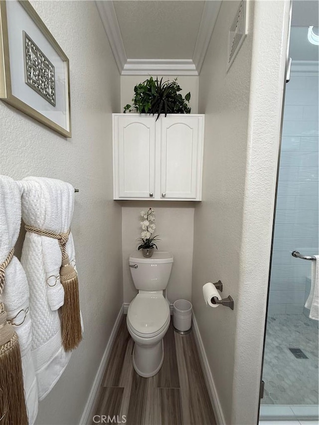 41410 Juniper St Unit 2012, Murrieta, CA 92562 - full bathroom featuring ornamental molding, a stall shower, toilet, baseboards, and wood finished floors