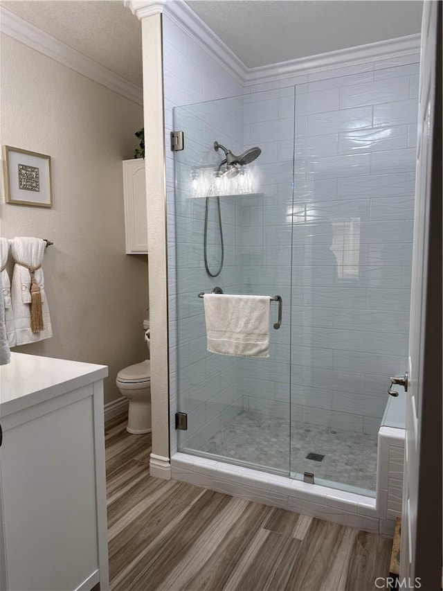 41410 Juniper St Unit 2012, Murrieta, CA 92562 - bathroom with ornamental molding, wood finished floors, toilet, a stall shower, and vanity