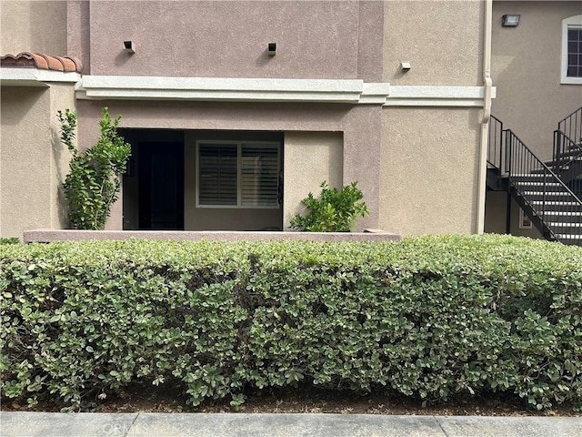 41410 Juniper St Unit 2012, Murrieta, CA 92562 - view of side of home with stucco siding and stairs