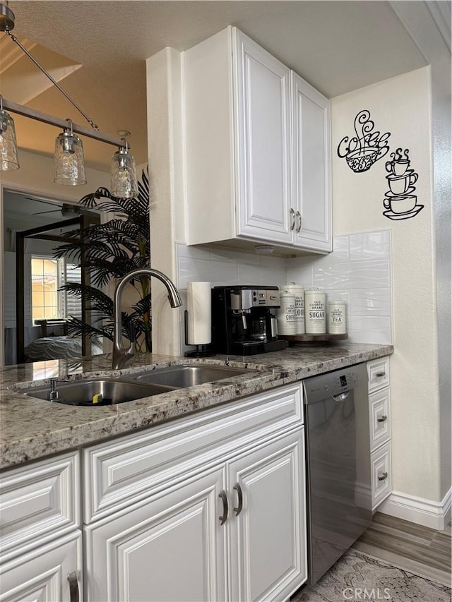 41410 Juniper St Unit 2012, Murrieta, CA 92562 - kitchen with dishwasher, a sink, white cabinets, and decorative backsplash