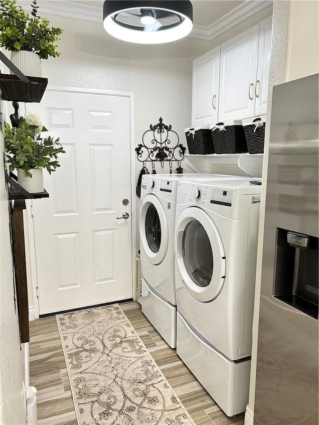 41410 Juniper St Unit 2012, Murrieta, CA 92562 - laundry room with washing machine and clothes dryer, light wood-style flooring, crown molding, and cabinet space