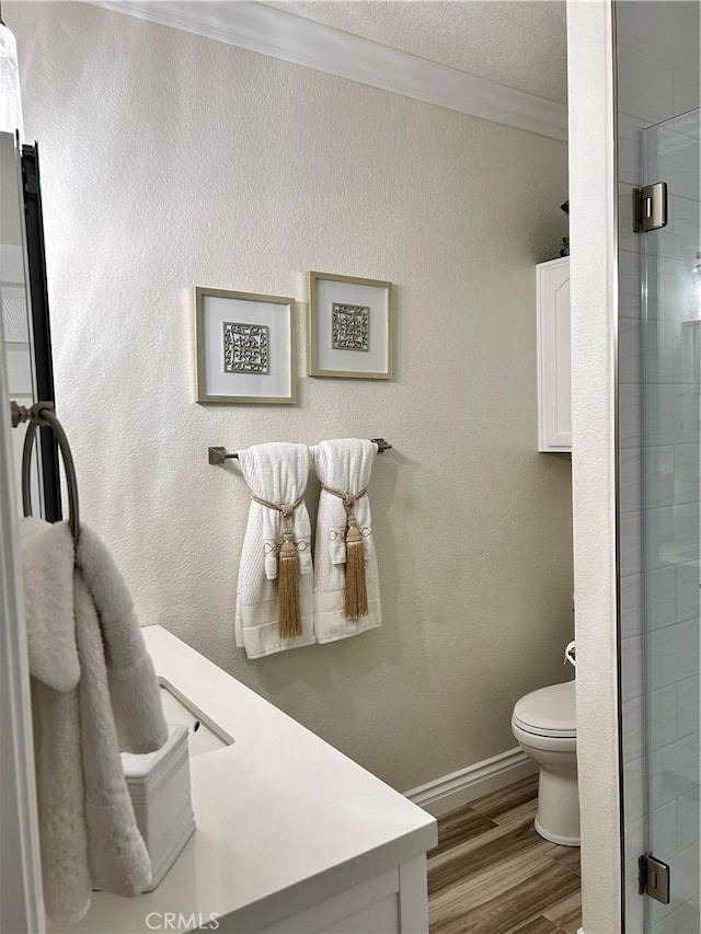 41410 Juniper St Unit 2012, Murrieta, CA 92562 - bathroom featuring a stall shower, ornamental molding, wood finished floors, and vanity