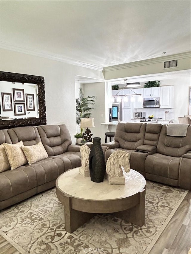41410 Juniper St Unit 2012, Murrieta, CA 92562 - living area featuring ornamental molding and light wood-type flooring