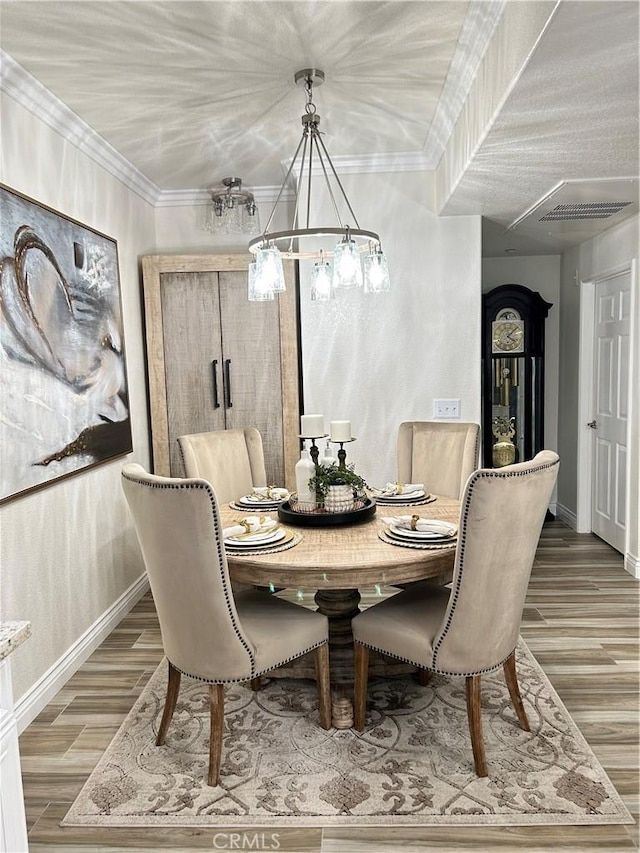 41410 Juniper St Unit 2012, Murrieta, CA 92562 - dining space with a chandelier, light wood-type flooring, and ornamental molding