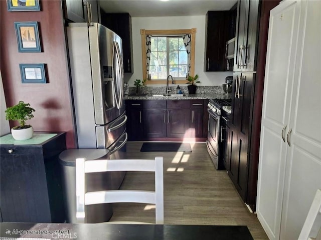 1707 Alta St, Redlands, CA 92374 - kitchen featuring appliances with stainless steel finishes, a sink, stone counters, and wood finished floors