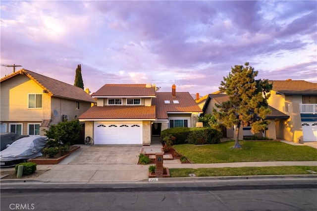 25421 Mina Ct, Lake Forest, CA 92630 - traditional home featuring a tiled roof, driveway, stucco siding, a yard, and an attached garage