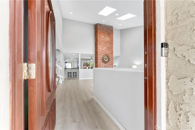 25421 Mina Ct, Lake Forest, CA 92630 - hallway with light wood-style flooring, baseboards, a skylight, and recessed lighting