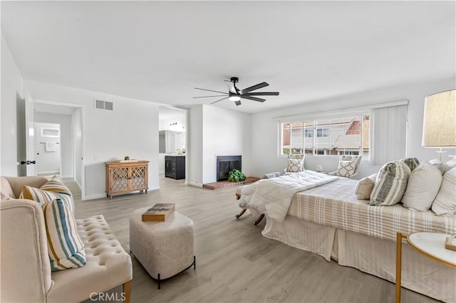 25421 Mina Ct, Lake Forest, CA 92630 - bedroom with wood finished floors, a fireplace with raised hearth, baseboards, a ceiling fan, and ensuite bath
