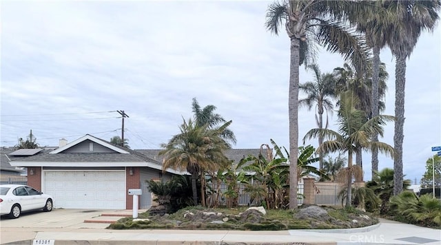 10301 Cutty Sark Dr, Huntington Beach, CA 92646 - view of front of house with a garage, driveway, brick siding, and a shingled roof