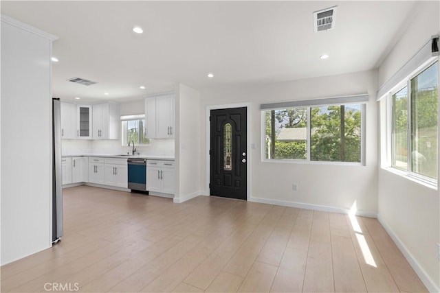 7714 Kyle St, Tujunga, CA 91042 - unfurnished living room with recessed lighting, baseboards, light wood finished floors, and a sink
