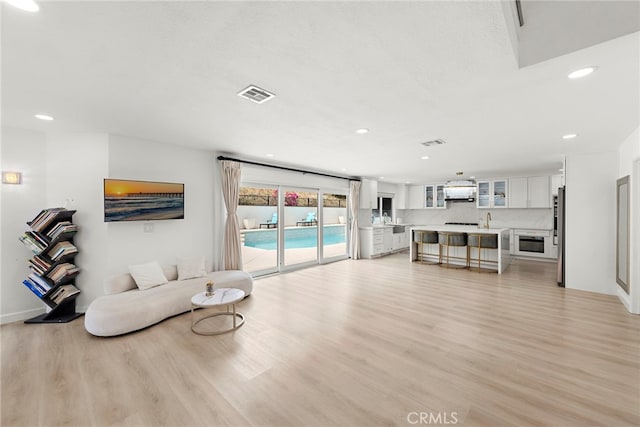 597 Rancheria Rd, Diamond Bar, CA 91765 - living area with light wood-type flooring, recessed lighting, and baseboards
