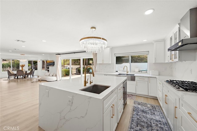 597 Rancheria Rd, Diamond Bar, CA 91765 - kitchen featuring a sink, stainless steel gas cooktop, wall chimney exhaust hood, light wood-type flooring, and recessed lighting