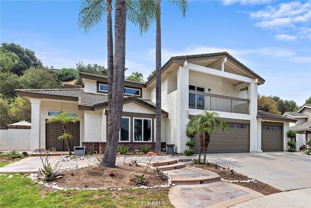 597 Rancheria Rd, Diamond Bar, CA 91765 - view of front facade featuring a balcony, concrete driveway, stucco siding, and a garage