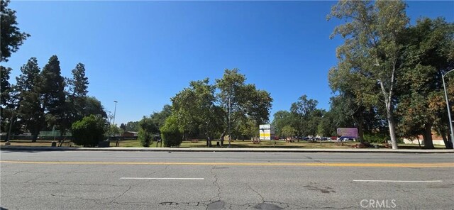 16701 Chatsworth St, Granada Hills, CA 91344 - view of asphalt road with street lights, curbs, and sidewalks