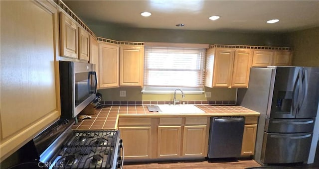 16701 Chatsworth St, Granada Hills, CA 91344 - kitchen featuring tile counters, stainless steel appliances, a sink, light brown cabinets, and recessed lighting
