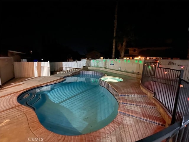 12413 Redrock Rd, Victorville, CA 92392 - pool at twilight with a pool with connected hot tub and a patio area