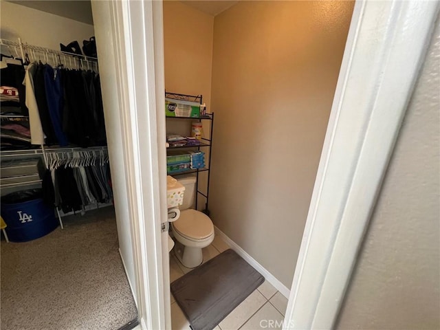 12413 Redrock Rd, Victorville, CA 92392 - bathroom with toilet, a spacious closet, and tile patterned floors