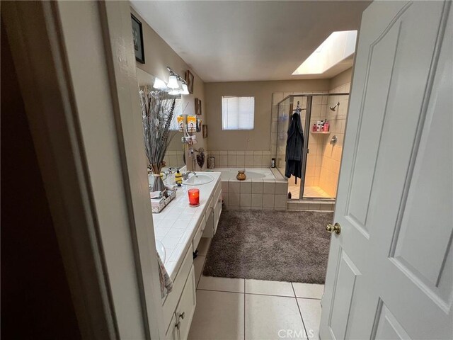 12413 Redrock Rd, Victorville, CA 92392 - full bathroom with tile patterned floors, double vanity, a skylight, a stall shower, and a bath