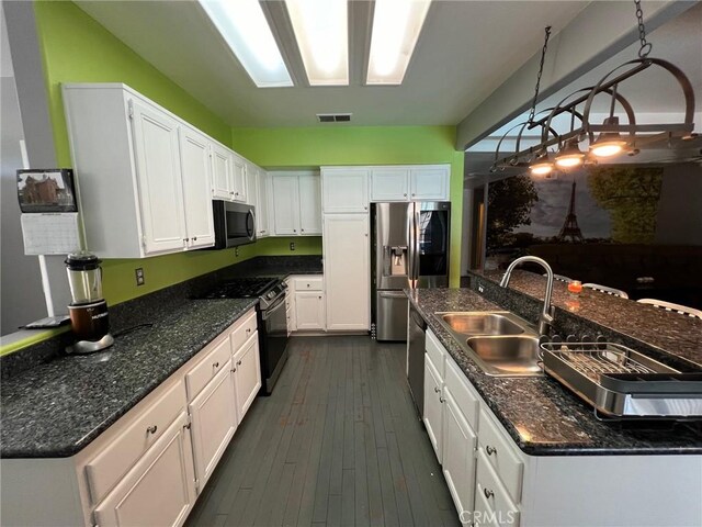 12413 Redrock Rd, Victorville, CA 92392 - kitchen with a sink, appliances with stainless steel finishes, white cabinetry, dark wood finished floors, and decorative light fixtures
