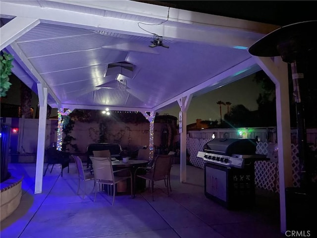 12413 Redrock Rd, Victorville, CA 92392 - patio at twilight featuring a gazebo, outdoor dining space, a patio area, and grilling area