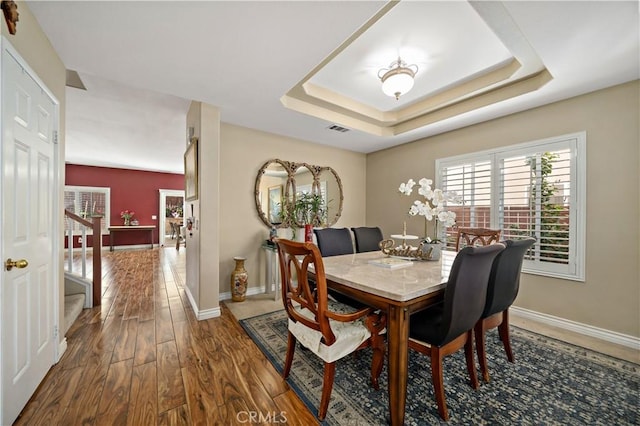 37814 Veranda Way, Murrieta, CA 92563 - dining space with wood finished floors, a tray ceiling, baseboards, and stairs