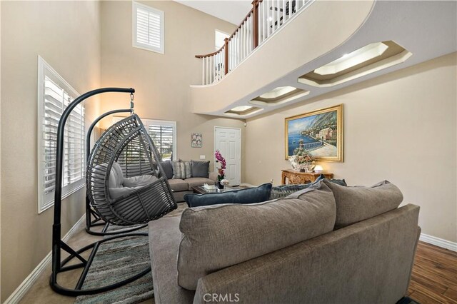 37814 Veranda Way, Murrieta, CA 92563 - living room featuring baseboards, plenty of natural light, wood finished floors, and a towering ceiling