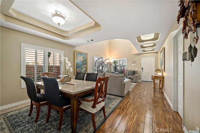 37814 Veranda Way, Murrieta, CA 92563 - dining space with a raised ceiling, arched walkways, wood finished floors, and baseboards