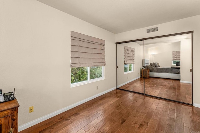 4243 Corte De La Siena, San Diego, CA 92130 - bedroom with hardwood / wood-style floors and baseboards
