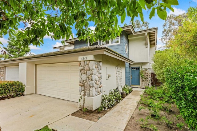 4243 Corte De La Siena, San Diego, CA 92130 - view of front of home with stone siding, stucco siding, concrete driveway, and a garage