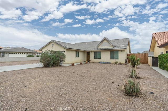 14752 Grafton Ln, Helendale, CA 92342 - ranch-style house featuring driveway, stucco siding, and a tiled roof